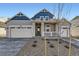 Charming two-story home with a covered porch, two-car garage, and manicured front yard at 39876 Floyd St, Elizabeth, CO 80107
