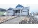 Lovely front exterior featuring a covered porch, attached garage, and neat landscaping details at 39876 Floyd St, Elizabeth, CO 80107