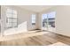 Well-lit living area featuring wood floors, large windows, and access to an outdoor patio at 39876 Floyd St, Elizabeth, CO 80107