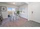 Bright dining area with table and chairs,sliding glass door and hardwood floors at 45004 Sunflower Ln, Bennett, CO 80102