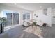 Open living room with a sectional sofa and sliding glass door to balcony at 45004 Sunflower Ln, Bennett, CO 80102