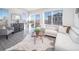 Spacious living room featuring a sectional sofa, a coffee table and large windows at 45004 Sunflower Ln, Bennett, CO 80102