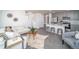 Open concept living and kitchen area with a large island and seating at 45004 Sunflower Ln, Bennett, CO 80102