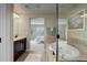 Luxurious bathroom featuring a soaking tub, a glass-enclosed shower, dark wood cabinets and tile flooring at 9592 Firenze Way, Highlands Ranch, CO 80126