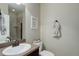 Clean bathroom featuring a sink, toilet, and shower with a neutral color scheme at 9592 Firenze Way, Highlands Ranch, CO 80126