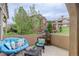 Cozy patio with comfortable seating and a peaceful view of the neighborhood and greenery at 9592 Firenze Way, Highlands Ranch, CO 80126
