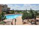 Resort style community pool surrounded by lush landscaping and comfortable lounge seating at 9592 Firenze Way, Highlands Ranch, CO 80126