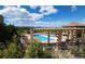 Community pool with pergola-covered seating area and scenic views at 9592 Firenze Way, Highlands Ranch, CO 80126