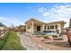 Serene backyard with a covered patio, lush lawn, and well-maintained landscaping, perfect for outdoor living at 17670 W 94Th Dr, Arvada, CO 80007