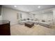 Spacious finished basement with large sectional, comfortable seating, and stylish furnishings at 17670 W 94Th Dr, Arvada, CO 80007