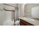 Full bathroom with a shower-tub combo, vanity with granite top, and neutral finishes at 17670 W 94Th Dr, Arvada, CO 80007