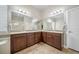 The bathroom features a dual sink vanity, granite countertops and tile flooring at 17670 W 94Th Dr, Arvada, CO 80007