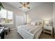Comfortable bedroom with a ceiling fan, large window, and closet space at 17670 W 94Th Dr, Arvada, CO 80007