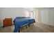 Cozy bedroom features twin beds with soft blue blankets, wood dressers, and neutral decor at 17670 W 94Th Dr, Arvada, CO 80007