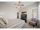 Cozy bedroom with a ceiling fan, window, and view of the home's staircase at 17670 W 94Th Dr, Arvada, CO 80007