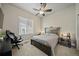 Bedroom featuring contemporary decor, a window for natural light, and a ceiling fan at 17670 W 94Th Dr, Arvada, CO 80007
