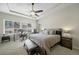 Main bedroom with tray ceilings, fan, carpet, and work space at 17670 W 94Th Dr, Arvada, CO 80007