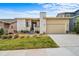 Contemporary home featuring a neutral color palette, stone accents, well-maintained lawn, and an attached two-car garage at 17670 W 94Th Dr, Arvada, CO 80007