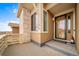 Inviting front porch with charming details, offering a warm welcome to visitors and enhancing curb appeal at 17670 W 94Th Dr, Arvada, CO 80007