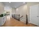 Open hallway with hardwood floors, leading to bright living spaces, connecting the home seamlessly at 17670 W 94Th Dr, Arvada, CO 80007