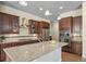 Spacious kitchen features granite counters, stainless appliances, and dark wood cabinets at 17670 W 94Th Dr, Arvada, CO 80007