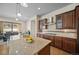 Bright open kitchen with large island and stainless steel vent hood at 17670 W 94Th Dr, Arvada, CO 80007
