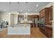 Bright, open kitchen with stainless steel appliances, a large island, and dark wood floors at 17670 W 94Th Dr, Arvada, CO 80007