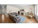 Bright living room with hardwood floors, fireplace and seating area, offering a comfortable space for relaxation at 17670 W 94Th Dr, Arvada, CO 80007