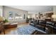 Inviting open-concept living area with hardwood floors, kitchen access, and natural light, perfect for gatherings at 17670 W 94Th Dr, Arvada, CO 80007