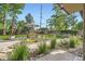 Landscaped backyard with a picnic table under an umbrella and lush foliage at 13211 W 32Nd Ave, Golden, CO 80401
