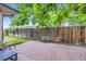 Backyard patio with privacy fence and mature trees providing shade at 13211 W 32Nd Ave, Golden, CO 80401
