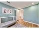 Cozy bedroom with wood floors, blue walls, and a white crib at 13211 W 32Nd Ave, Golden, CO 80401