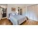 Bright bedroom with hardwood floors, striped bedding, and ample closet space, providing a cozy retreat at 13211 W 32Nd Ave, Golden, CO 80401