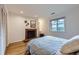 Cozy bedroom featuring a fireplace, window views, and hardwood floors, creating a warm ambiance at 13211 W 32Nd Ave, Golden, CO 80401