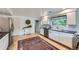 Well-lit kitchen with stainless steel appliances, white cabinets, and hardwood floors at 13211 W 32Nd Ave, Golden, CO 80401