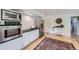 Modern kitchen with stainless steel appliances, white cabinets, and hardwood flooring at 13211 W 32Nd Ave, Golden, CO 80401