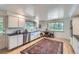 Bright kitchen featuring white cabinets, stainless steel appliances, and an eat-in area at 13211 W 32Nd Ave, Golden, CO 80401