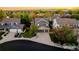 Aerial view of a two-story house with gray siding, three-car garage, and a well-maintained yard at 2973 E 135Th Way, Thornton, CO 80241