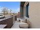 Cozy brick balcony with comfortable seating offering a blend of privacy and city views at 4072 W 17Th Ave, Denver, CO 80204