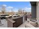 Brick balcony with seating offers a street view and a glimpse of the nearby lake at 4072 W 17Th Ave, Denver, CO 80204