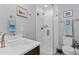 Modern bathroom features a walk-in shower with glass doors, a white sink, and stylish fixtures at 4072 W 17Th Ave, Denver, CO 80204