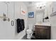 Stylish bathroom with a modern vanity, elegant fixtures, contemporary art, and tiled shower at 4072 W 17Th Ave, Denver, CO 80204