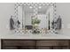 Bathroom featuring a double sink vanity with bronze hardware, decorative mirror and fresh decor at 4072 W 17Th Ave, Denver, CO 80204