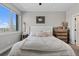 Neutral bedroom featuring a large window, soft natural light, a comfortable bed, and rustic modern accents at 4072 W 17Th Ave, Denver, CO 80204