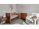 Adorable Bedroom with a wooden crib, white armchair, and neutral-toned decor at 4072 W 17Th Ave, Denver, CO 80204