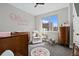 Charming Bedroom with a crib, rocking chair, and serene decor accents at 4072 W 17Th Ave, Denver, CO 80204