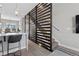 Modern entryway with a decorative wood screen separating the foyer from the stairway at 4072 W 17Th Ave, Denver, CO 80204