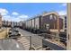 Modern townhome exteriors featuring garages, balconies and street parking at 4072 W 17Th Ave, Denver, CO 80204
