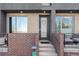 Charming front entrance with brick accents, modern door, and inviting steps at 4072 W 17Th Ave, Denver, CO 80204