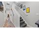 Hallway with art-lined stairs and a bright entry leading to the home's living spaces at 4072 W 17Th Ave, Denver, CO 80204